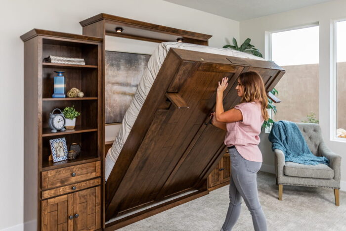 woman opening wall bed